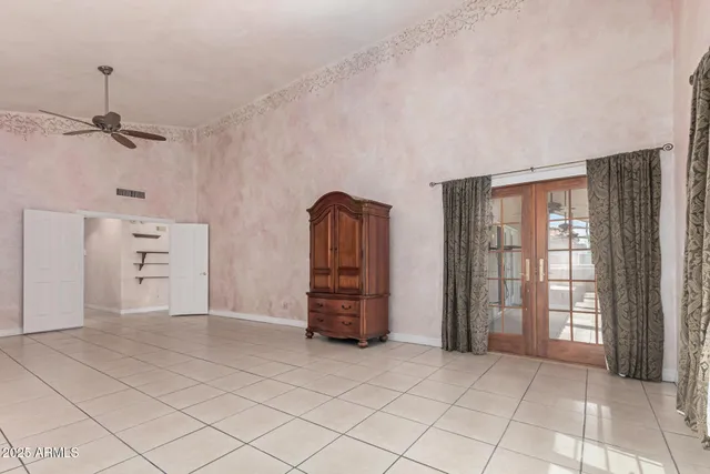 an empty room with closet and windows