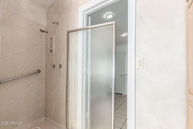 a bathroom with a glass shower door