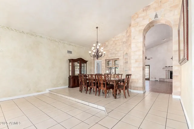 a view of a dining room with furniture and chandelier