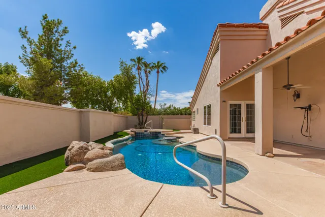 a view of a house with backyard and sitting area