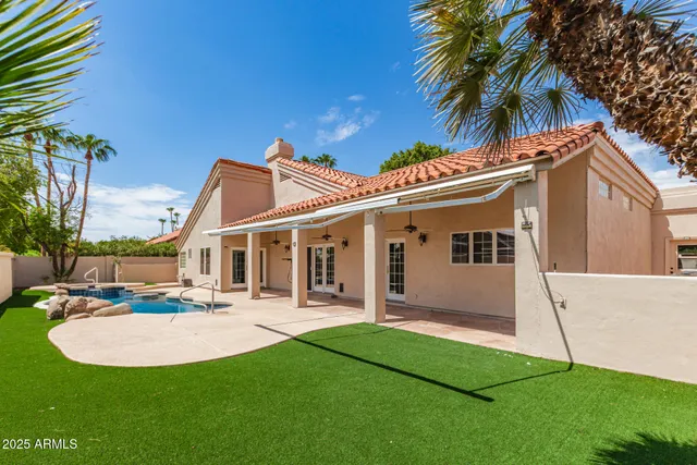 a view of a backyard with couches chair and grass