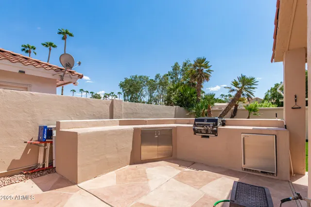 a front view of a house with a yard and palm trees