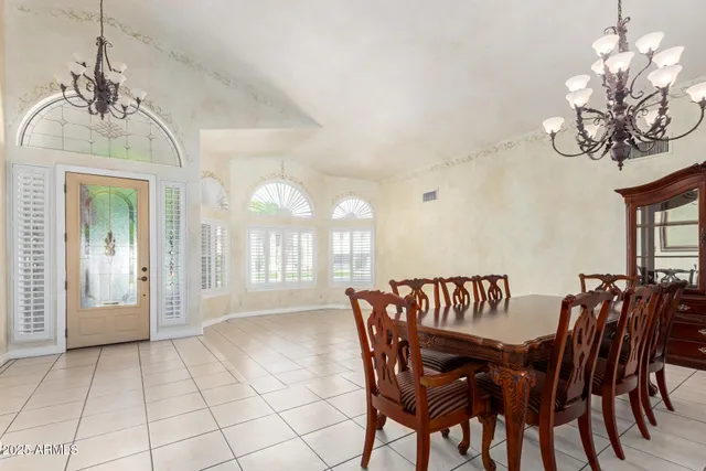 a view of a dining room with furniture and chandelier