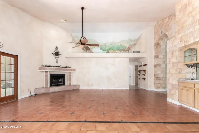 a view of a livingroom with a fireplace a sink and dishwasher