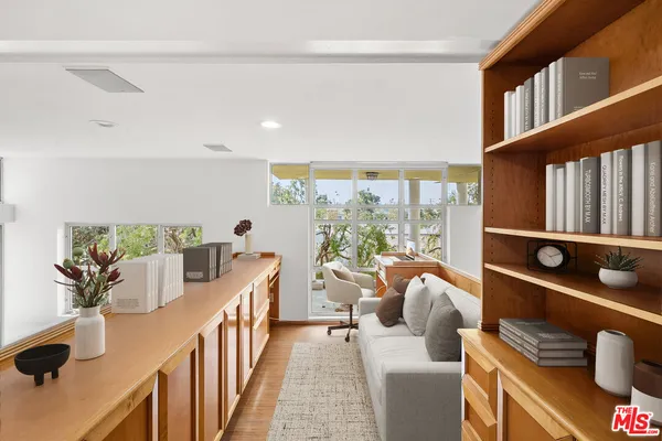 a living room with furniture and a floor to ceiling window