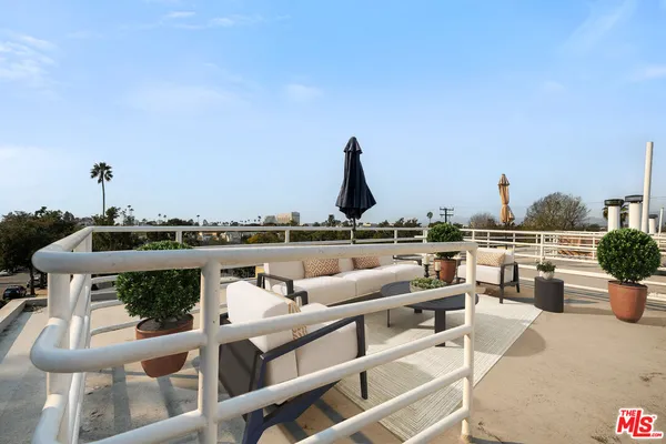 a view of roof deck with furniture