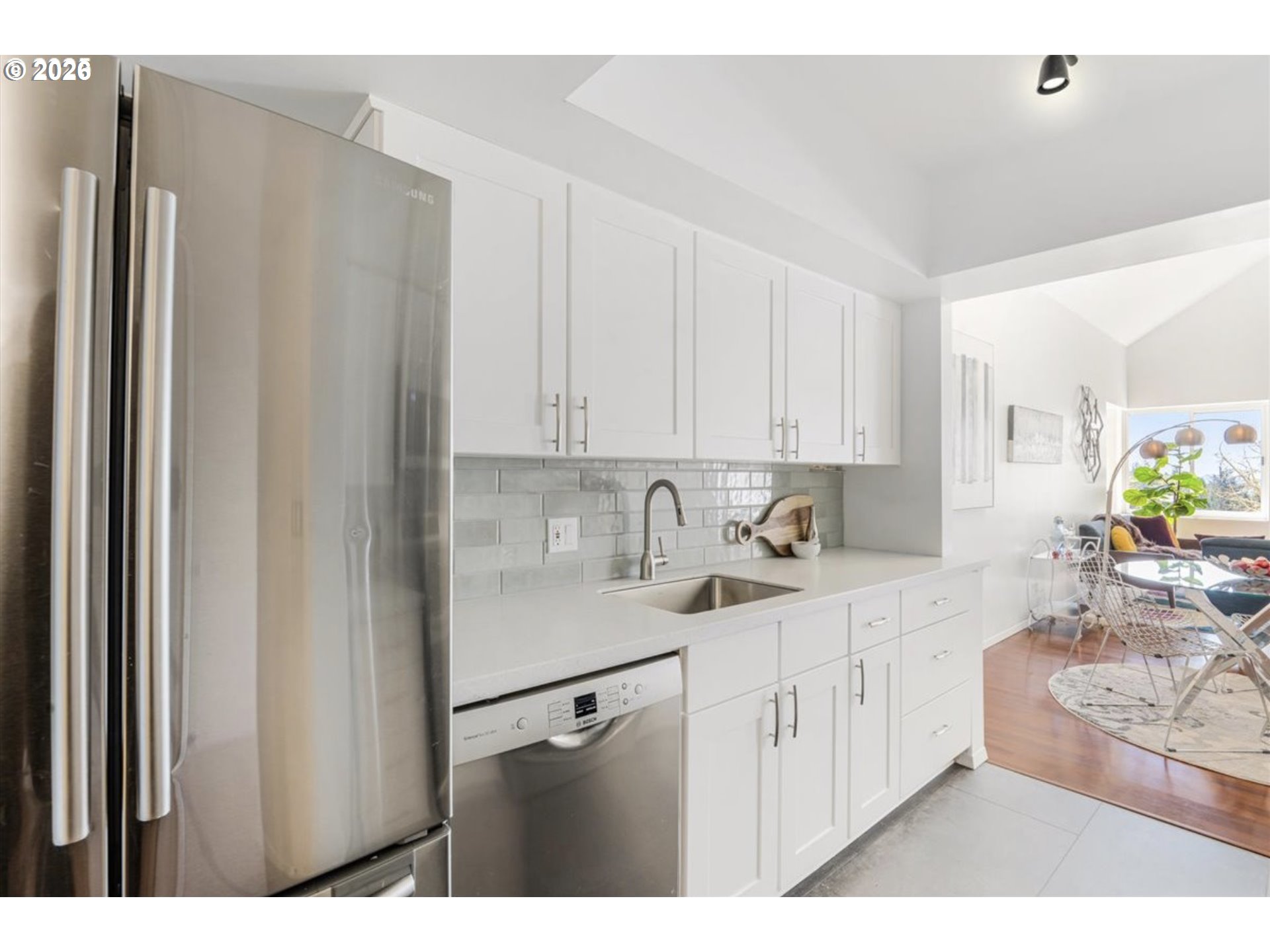 6645 West Burnside Street, Unit 550 Portland, OR 97225 - Photo 4 of 38 a kitchen with white cabinets and refrigerator
