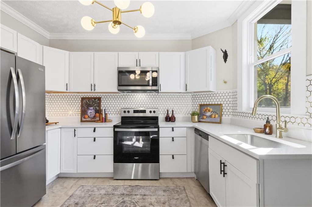 210 Elm Street Pittsburgh, PA 15218 - Photo 15 of 36 a kitchen with stainless steel appliances a stove a sink cabinets a refrigerator and a stove