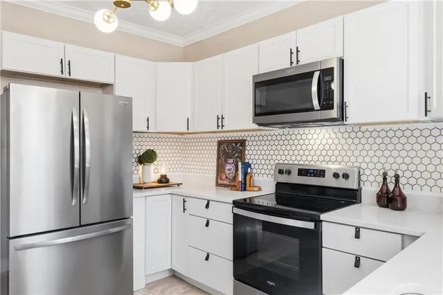 a view of a dining room with furniture and chandelier