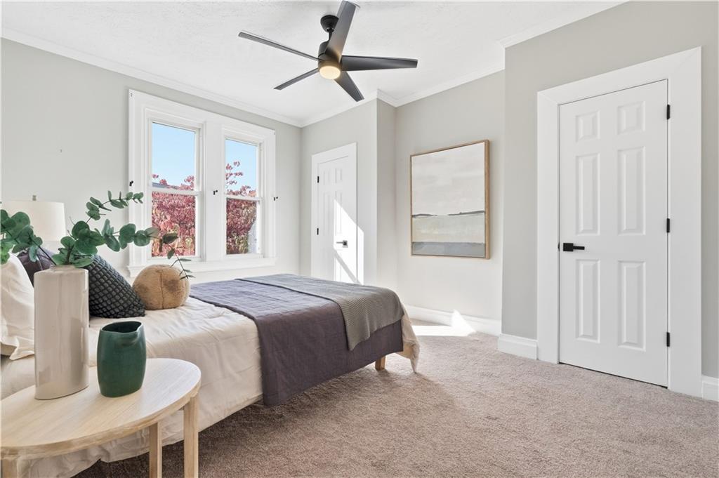 210 Elm Street Pittsburgh, PA 15218 - Photo 20 of 36 a bedroom with a bed and a chandelier