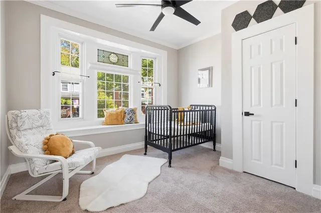 a spacious bedroom with a bed and window