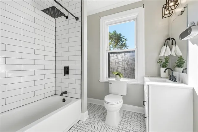 a bathroom with a toilet a sink and mirror