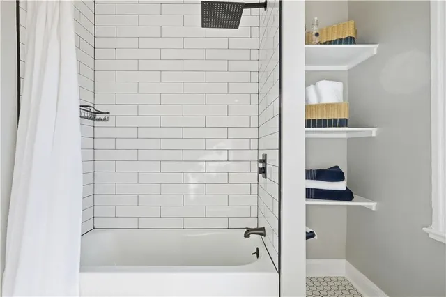 a spacious bedroom with a bed a couch and a window