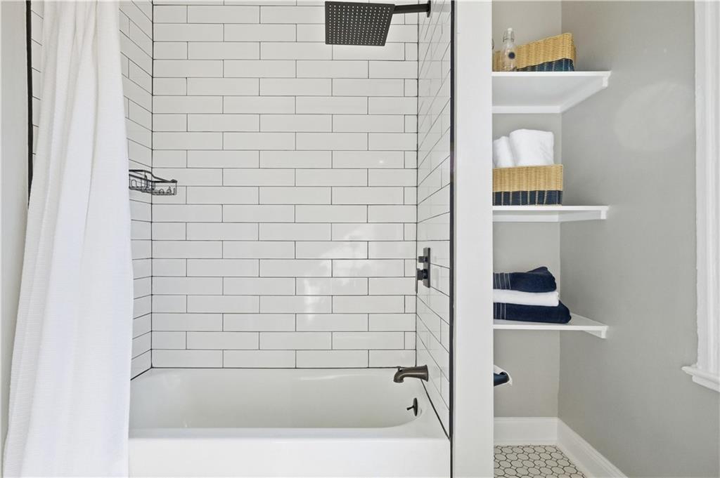 210 Elm Street Pittsburgh, PA 15218 - Photo 26 of 36 a bathroom with a bathtub and a shower
