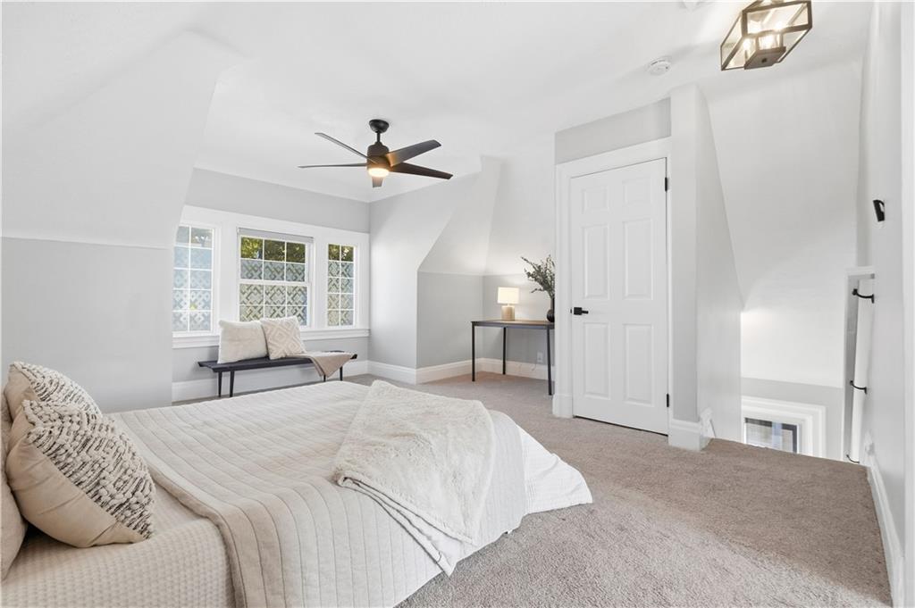 210 Elm Street Pittsburgh, PA 15218 - Photo 28 of 36 a bedroom with a large bed and a chandelier