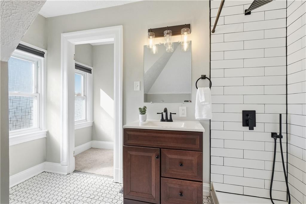 210 Elm Street Pittsburgh, PA 15218 - Photo 29 of 36 a bathroom with a sink a toilet and mirror