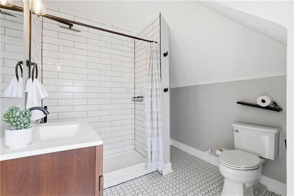 210 Elm Street Pittsburgh, PA 15218 - Photo 30 of 36 a bathroom with a sink a toilet and shower