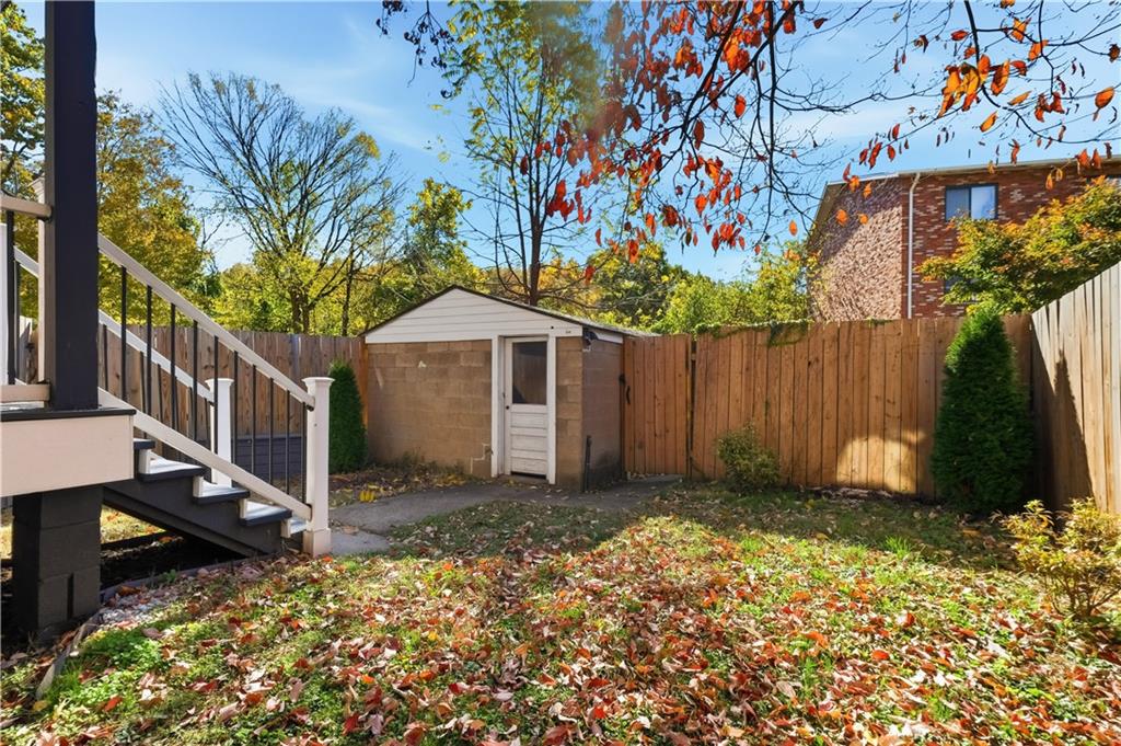 210 Elm Street Pittsburgh, PA 15218 - Photo 34 of 36 a backyard of a house with lots of green space and wooden fence