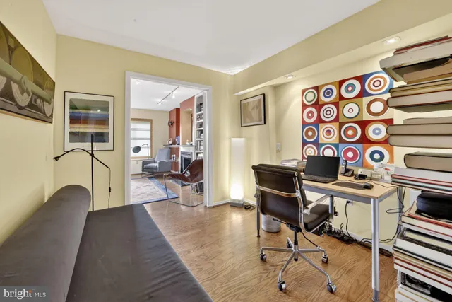a view of a workspace with furniture and a window