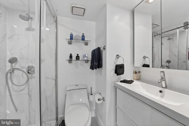 a bathroom with a toilet sink and shower