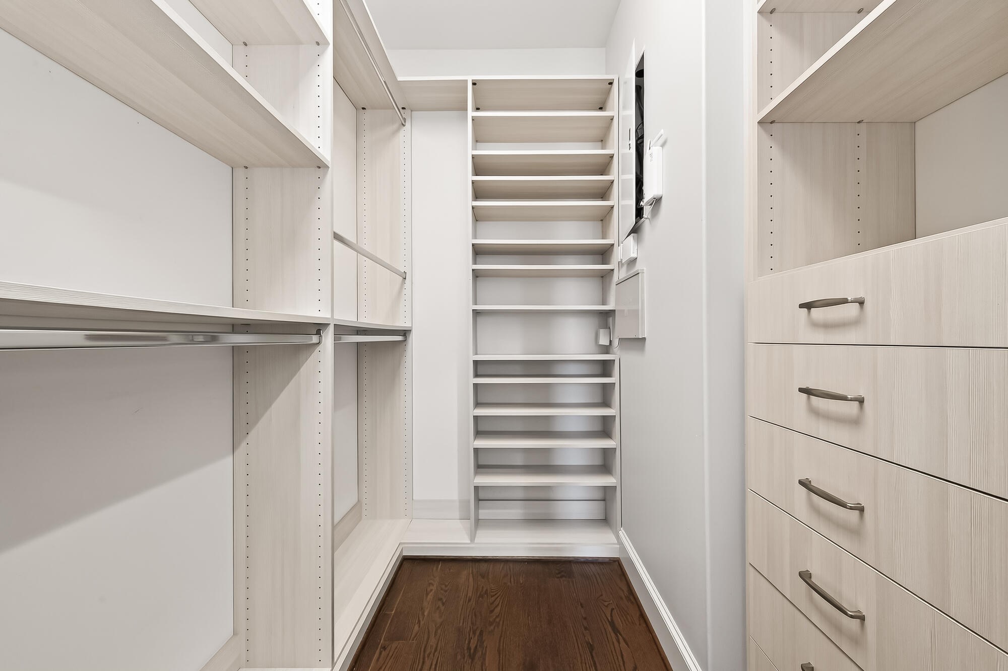 122 Gateway Park Place Spring, TX 77380 - Photo 32 of 44 Custom walk-in closet with built-in shelving, hanging rods, and drawer storage over rich wood flooring.
