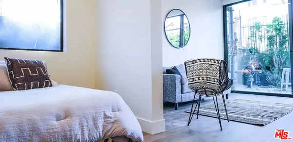 a bedroom with a bed a lamp and a window