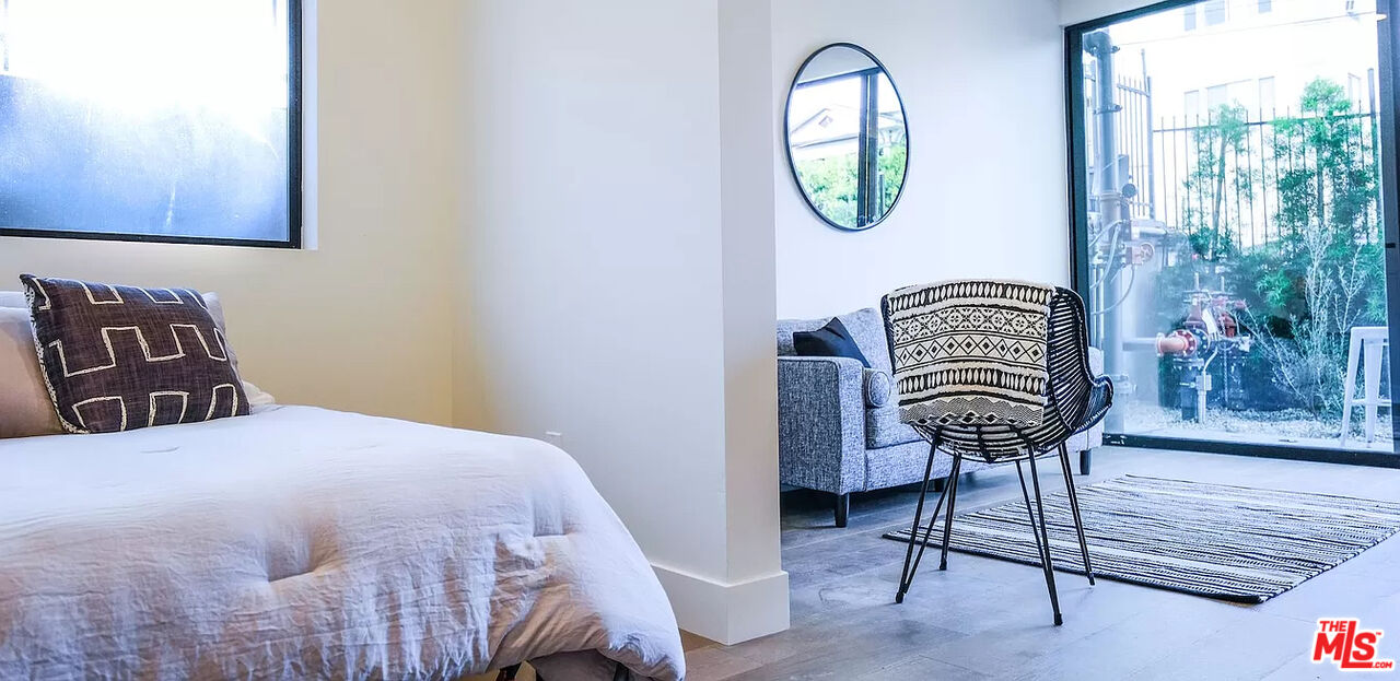 321 North Bixel Street, Unit 2 Los Angeles, CA 90026 - Photo 1 of 22 a bedroom with a bed a lamp and a window