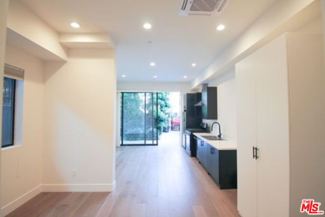 321 North Bixel Street, Unit 2 Los Angeles, CA 90026 - Photo 17 of 22 a view of a large kitchen with wooden floor and a window