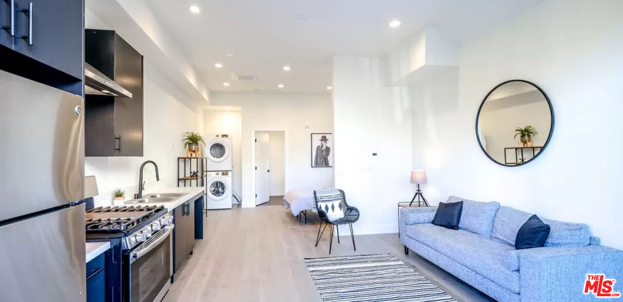 321 North Bixel Street, Unit 2 Los Angeles, CA 90026 - Photo 3 of 22 a living room with furniture and a mirror