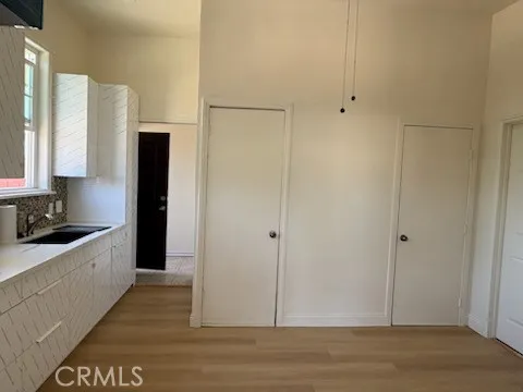 a view of a kitchen with a sink and a refrigerator