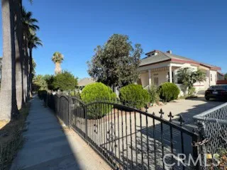 a view of a house with wooden fence