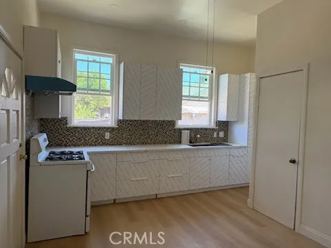 a kitchen with granite countertop cabinets stainless steel appliances a sink and a window