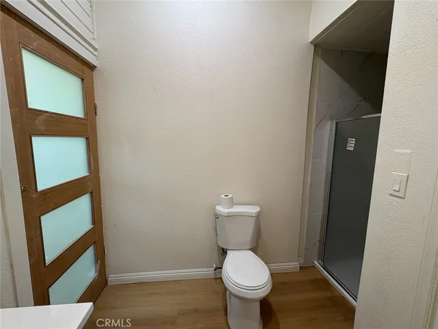 a white toilet sitting next to a small sink