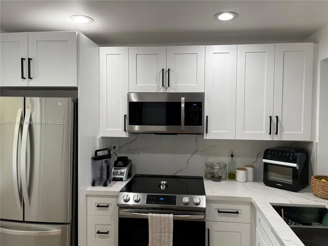 a kitchen with counter top space and cabinets