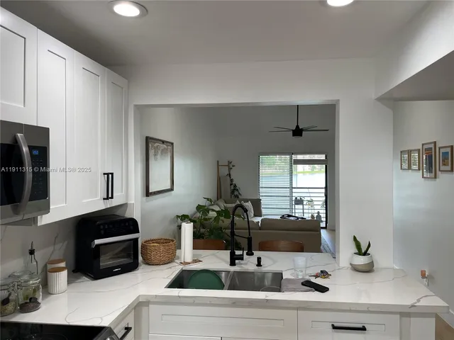 a kitchen with a refrigerator sink and microwave
