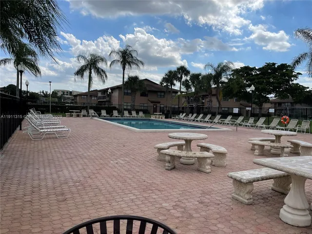 a front view of a house with a yard and tree s