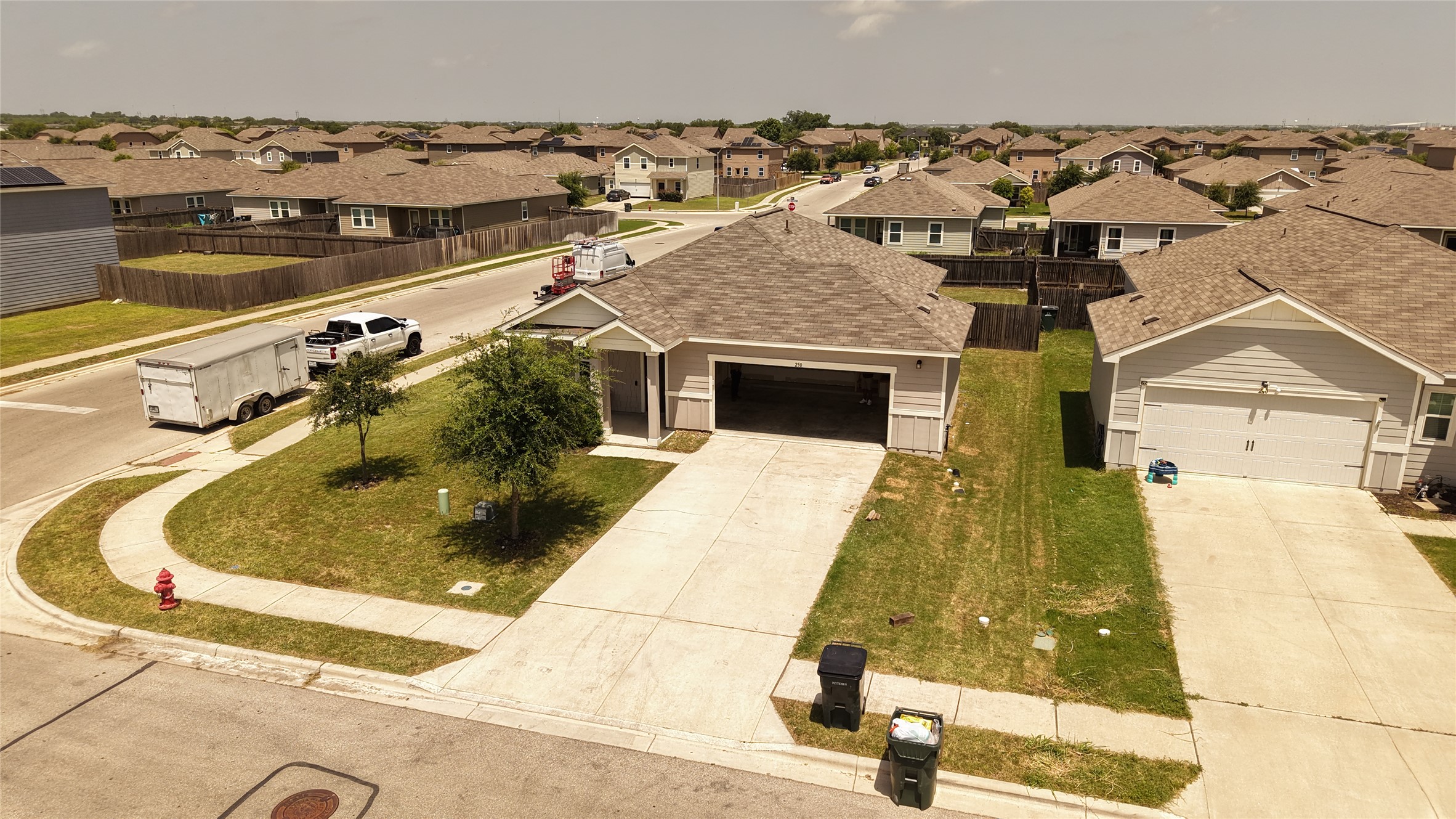 250 Seneca Loop Kyle, TX 78640 - Photo 19 of 22 An inviting suburban dwelling with a private driveway awaits, featuring an attached garage and a well-kept lawn.