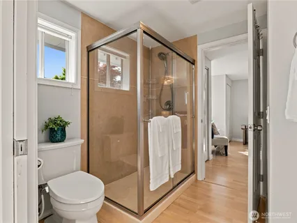 a bathroom with a glass shower door