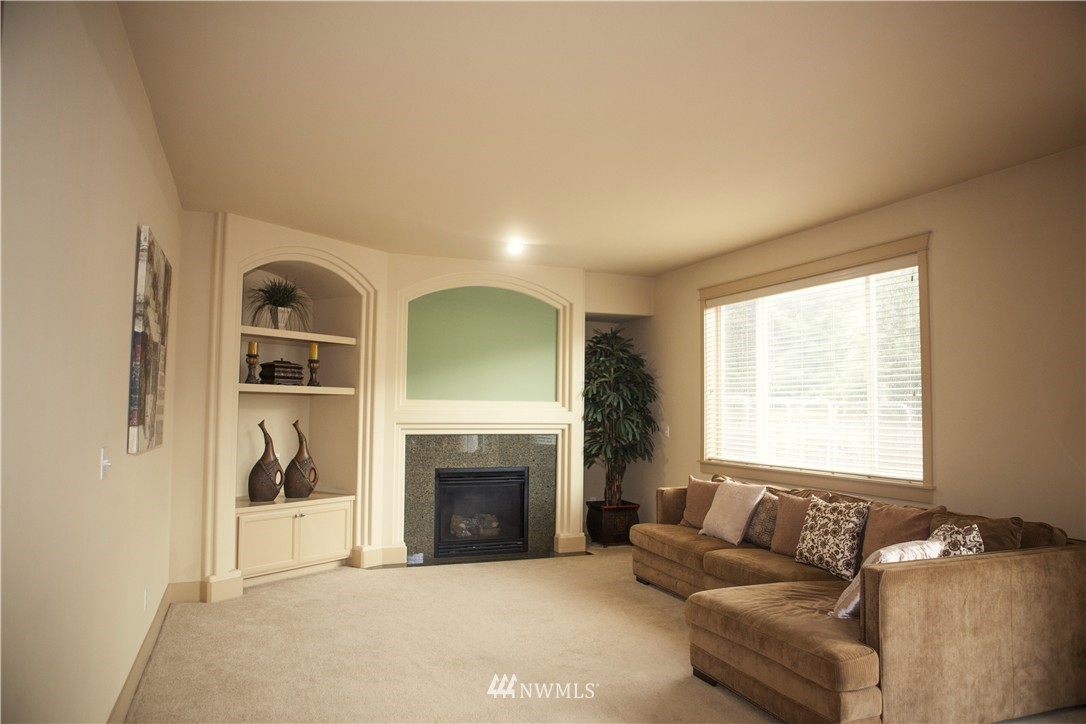 3808 186th Street Southeast Bothell, WA 98012 - Photo 11 of 25 a living room with furniture and a fireplace