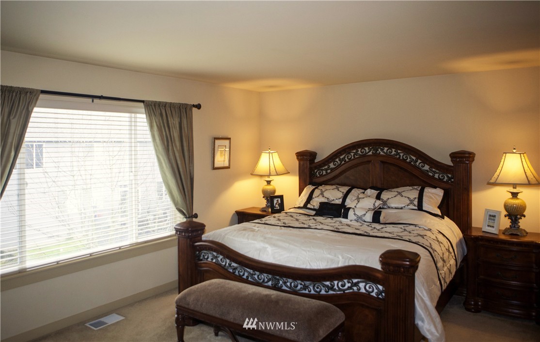 3808 186th Street Southeast Bothell, WA 98012 - Photo 16 of 25 a bedroom with a bed a mirror and a window