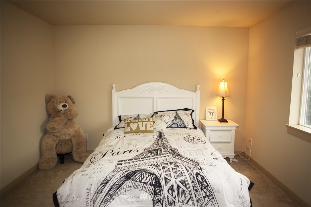3808 186th Street Southeast Bothell, WA 98012 - Photo 20 of 25 a bedroom with a bed and a chandelier