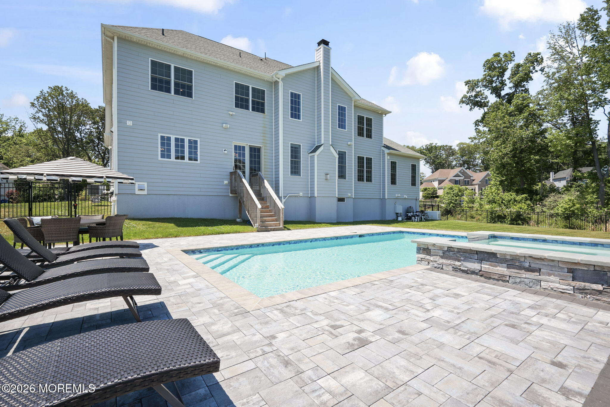 66 Windermere Road Lincroft, NJ 07738 - Photo 5 of 48 a view of a house with a swimming pool and sitting area