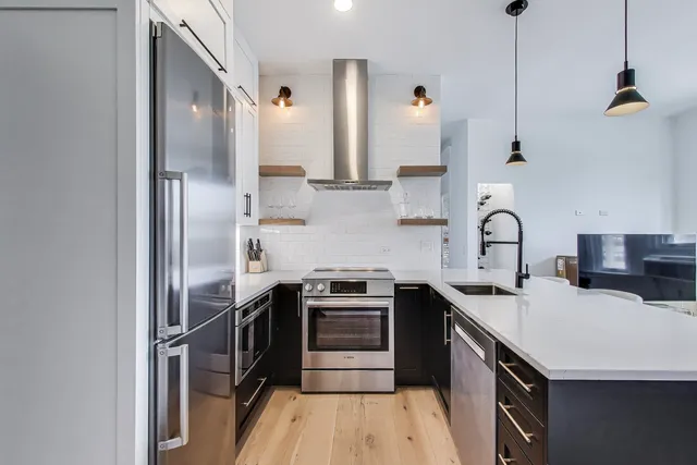 a kitchen with a sink appliances and cabinets