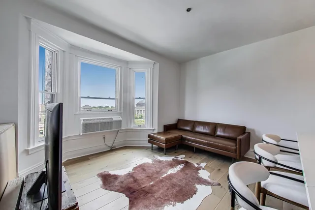 a living room with furniture and a rug