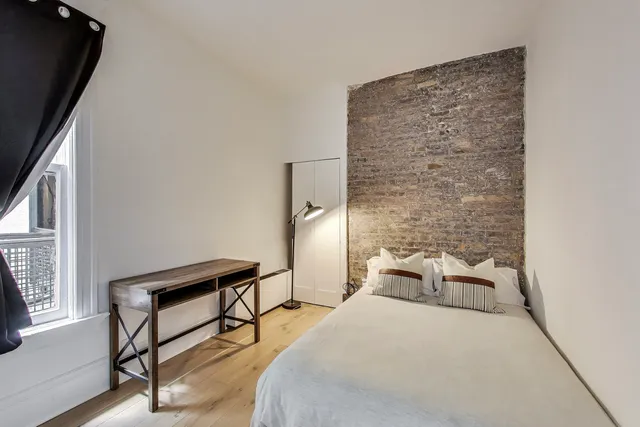 a bedroom with a bed and a dresser