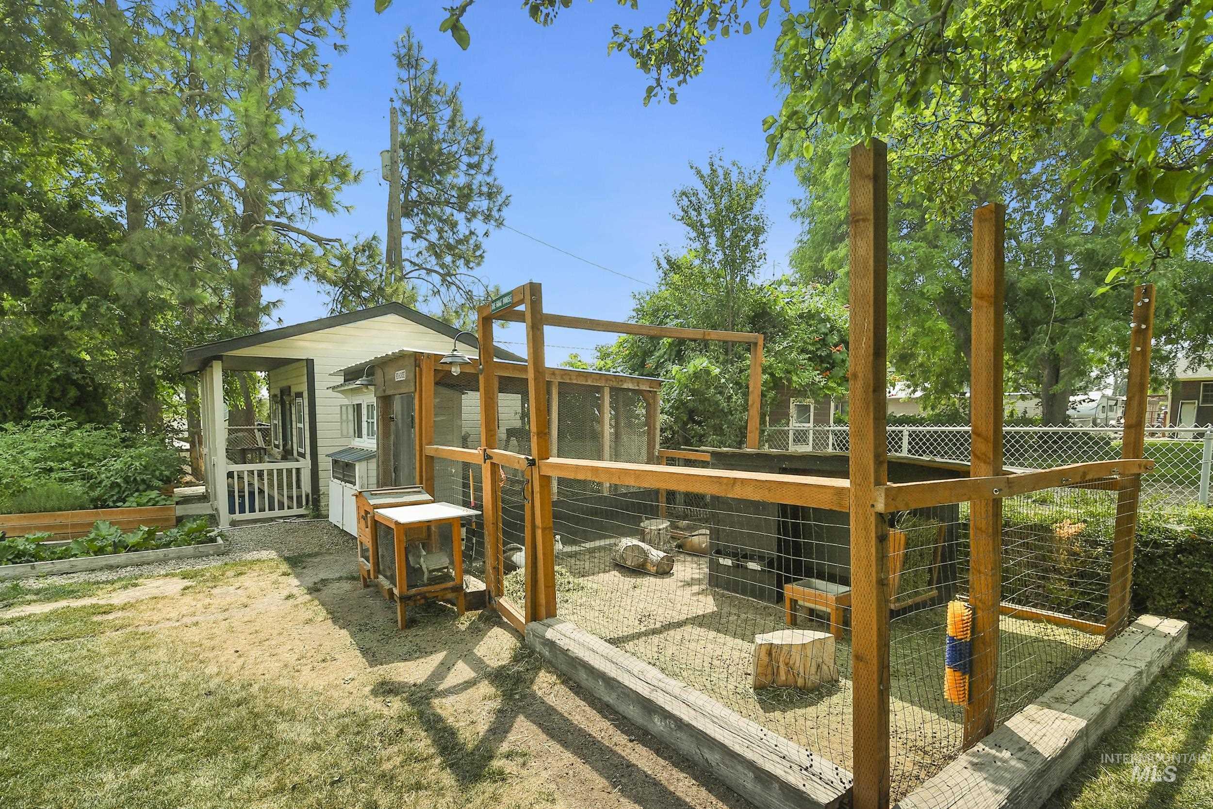 127 Ruth Lane Nampa, ID 83686 - Photo 44 of 49 Expansive green lawn bordering a two-story residence with a covered patio, upper-level balcony, and a detached structure