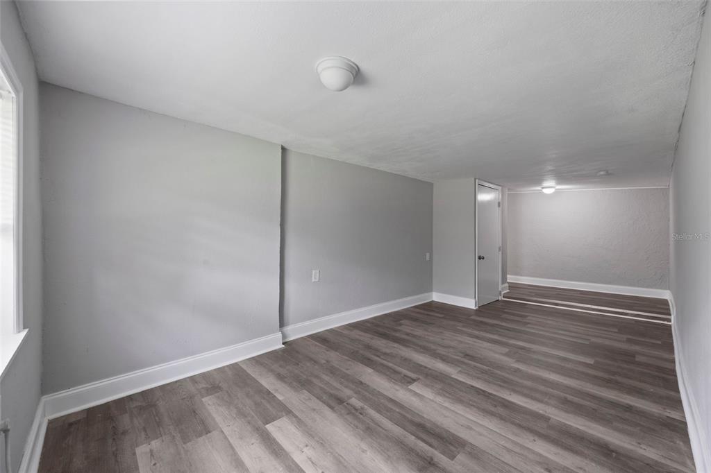5045 Green Key Road New Port Richey, FL 34652 - Photo 22 of 32 a view of an empty room with wooden floor