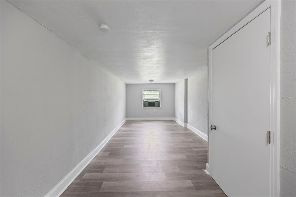 5045 Green Key Road New Port Richey, FL 34652 - Photo 23 of 32 a view of a hallway with wooden floor and a cabinet