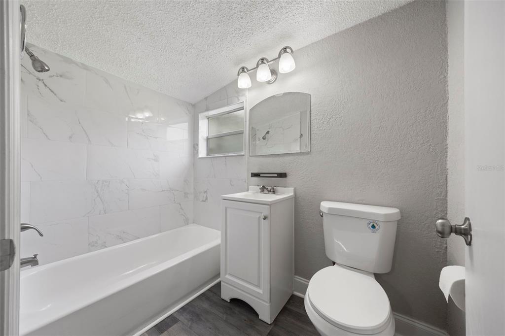 5045 Green Key Road New Port Richey, FL 34652 - Photo 24 of 32 a white toilet sitting next to a bathtub