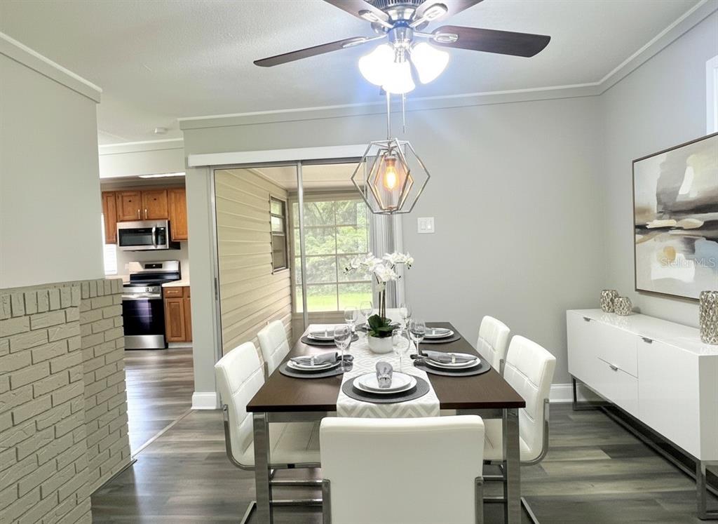 5045 Green Key Road New Port Richey, FL 34652 - Photo 6 of 32 a view of a dining room with furniture a chandelier and wooden floor